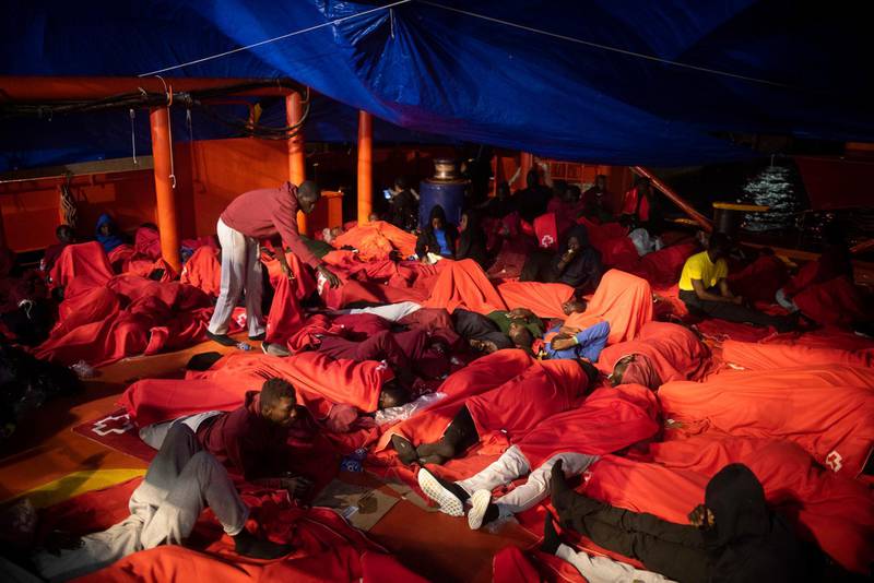 In this Monday, July 30 , 2018 photo, migrants rest inside a rescue vessel at the port of Algeciras, southern Spain, after being rescued by Spain's Maritime Rescue Service in the Strait of Gibraltar. Spain's foreign minister says the European Union's executive branch has allocated 55 million euros ($64.2 million) to manage an upsurge of migrant arrivals mostly from Morocco. With nearly 23,000 arrivals recorded so far, Spain has become this year the main entry point into Europe for migrants crossing the Mediterranean Sea by boat. (AP Photo/Marcos Moreno)