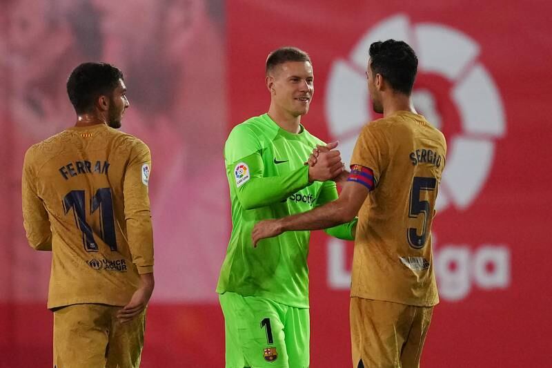 Marc-Andre ter Stegen celebrates victory with Sergio Busquets and Ferran Torres. Getty