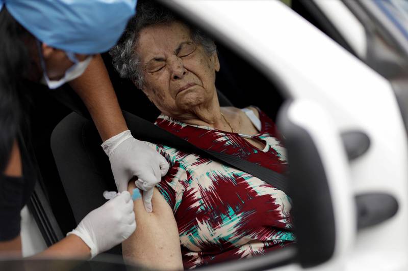 A health worker vaccinates a woman against the flu, as advised by health officials to facilitate diagnosis for coronavirus, amid the coronavirus disease (COVID-19) outbreak, in Brasilia, Brazil. Reuters