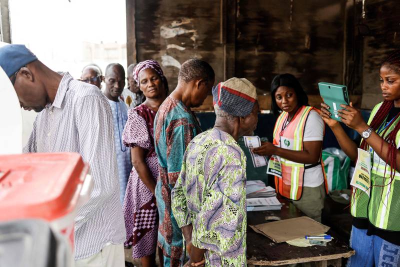 An official confirms the details of a voter at a polling station in Agege. AFP