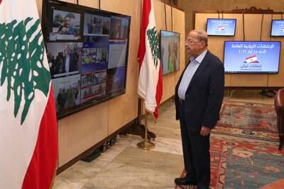 Lebanese President Michel Aoun follows the parliamentary elections on screens from the Presidential Palace in Beirut. AP