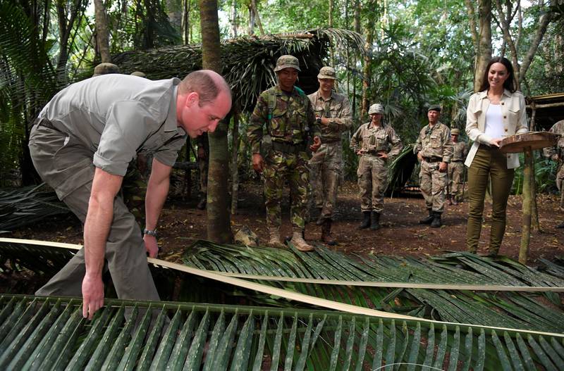 The prince splits a palm leaf during a water collecting demonstration. PA