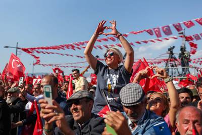 Supporters of Mr Kilicdaroglu make the heart gesture in Izmir. Republican People's Party Press Service / AFP
