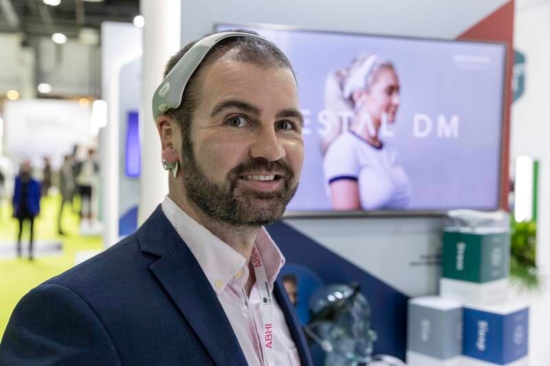 Jason McKeown, chief executive of Neurovalens, demonstrates the Vestal DM device at Arab Health in Dubai. Antonie Robertson / The National