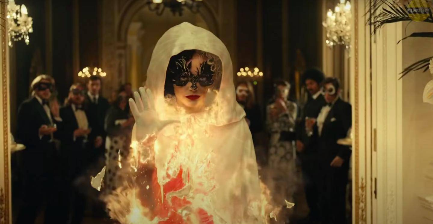 Emma Stone's 'Cruella' character sets alight a white cape to reveal a striking red dress in the newly released trailer. Courtesy Disney 