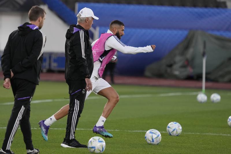 Real Madrid's Karim Benzema, right, and coach Carlo Ancelotti, centre, attend the training session for the UEFA Super Cup final. AP