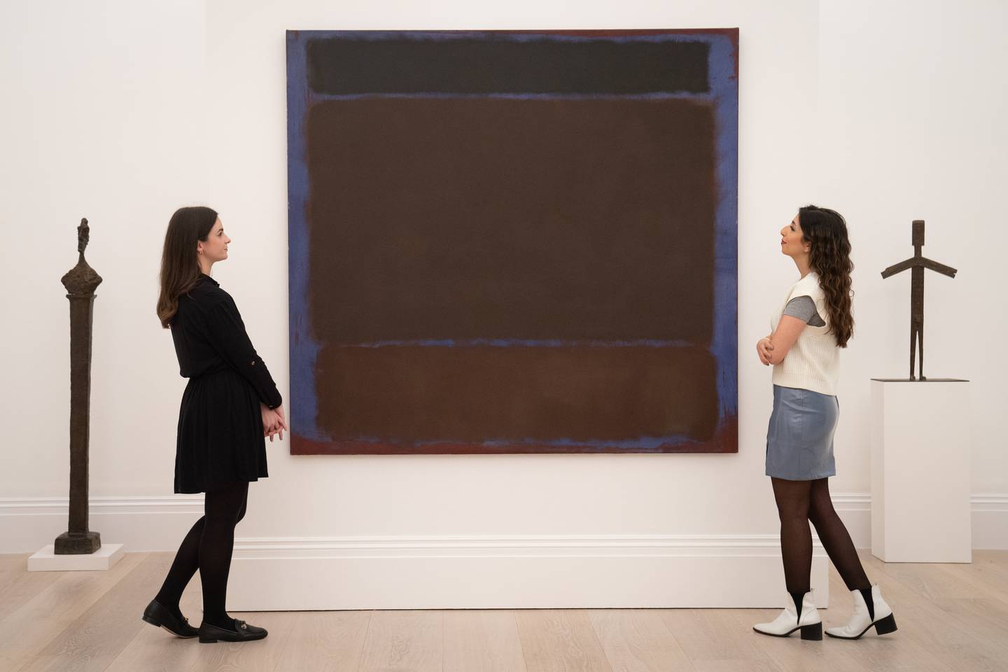 Gallery staff look at artworks from the Macklowe Collection during a photo call at Sotheby's in London before it was offered at auction in New York in February 2022. PA Wire