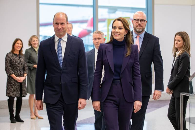 For their arrival at Boston airport, Prince William opted for a dark blue suit with light blue tie, while the Princess of Wales wore a tailored suit by Alexander McQueen in aubergine. AFP