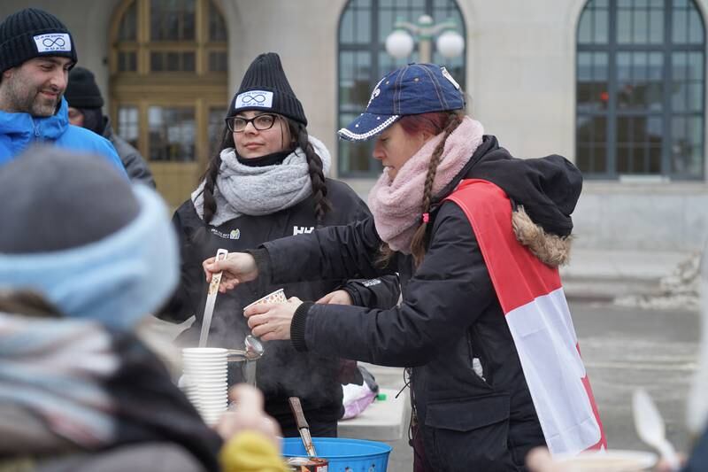 A woman hands out soup to protesters. Willy Lowry / The National
