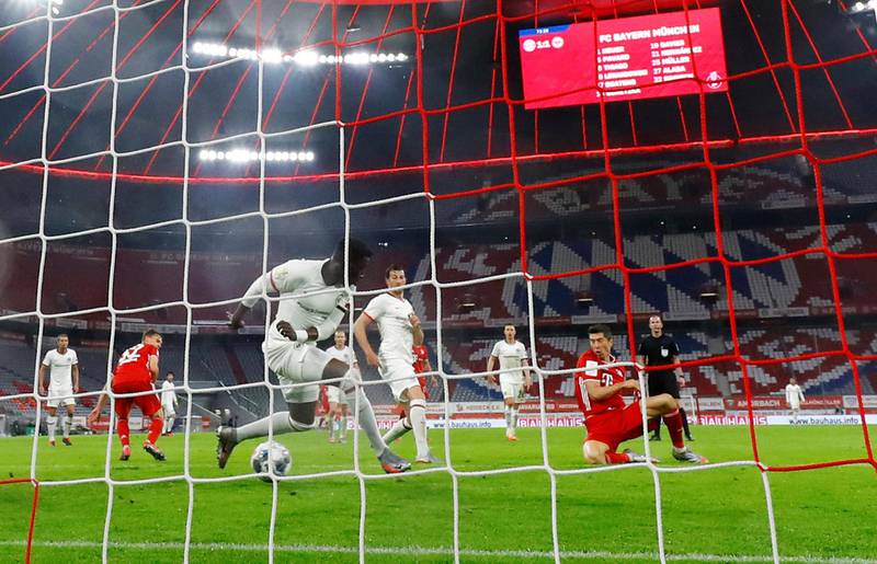 Bayern Munich's Robert Lewandowski, right, scores his goal. AP