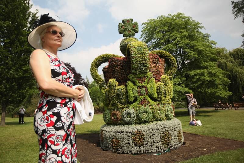 Members of the public admire a large floral crown made to mark the diamond jubilee in St James's Park, London in May 2012.
