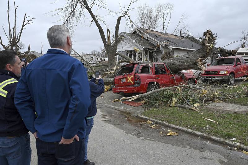Mayor Clint Lamb and Indiana governor Eric Holcomb survey the damage in Sullivan. AP