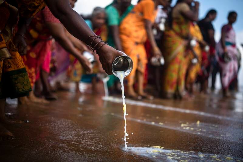 People pour milk in the waters of the Bay of Bengal as they honour the victims of the 2004 Indian Ocean tsunami disaster, in Chennai, India.   EPA 