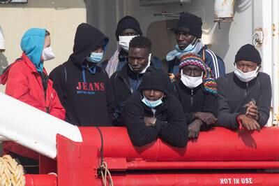 Migrants wait to disembark the rescue ship Ocean Viking after it arrived at the Italian port of Ravenna. EPA