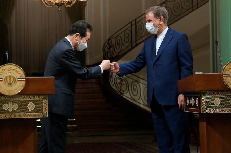 Iranian Senior Vice- President, South Korea's Prime Minister Chung Sye-kyun, left, and Iran's Senior Vice-President Eshaq Jahangiri touch fists during their joint press briefing, in Tehran, Iran. AP Photo