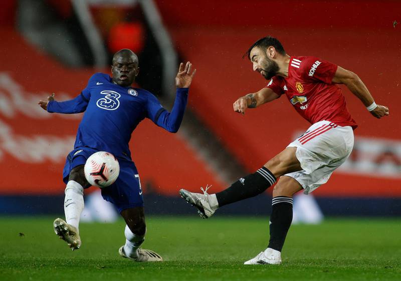 Chelsea's N'Golo Kante, left, tries to block a shot from Manchester United's Bruno Fernandes at the Old Trafford stadium in Manchester on Saturday. AP