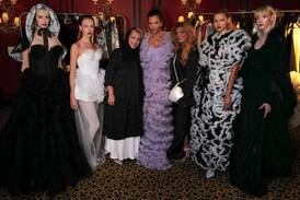 Model Helena Christensen, centre, flanked by Atelier Hekayat designers Alia and Abeer Oraif at their fashion show in London. Photo: AlUla Creates / British Fashion Council