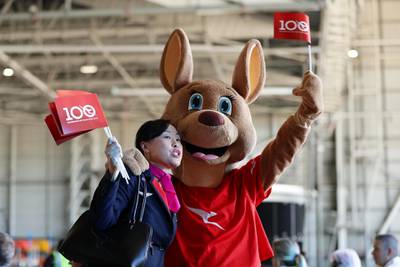 A Qantas worker poses with the Qantas mascot. Getty Images