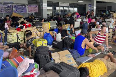 Stranded passengers fill a boarding terminal at a port in Manila after sea travel was suspended due to the typhoon. AP