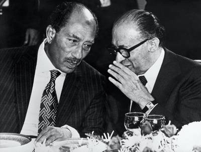 Egyptian President Anouar el-Sadate (L) meets Israeli Prime minister Menahem Begin in Tel Aviv on November 23, 1977. (Photo by STF / AFP)