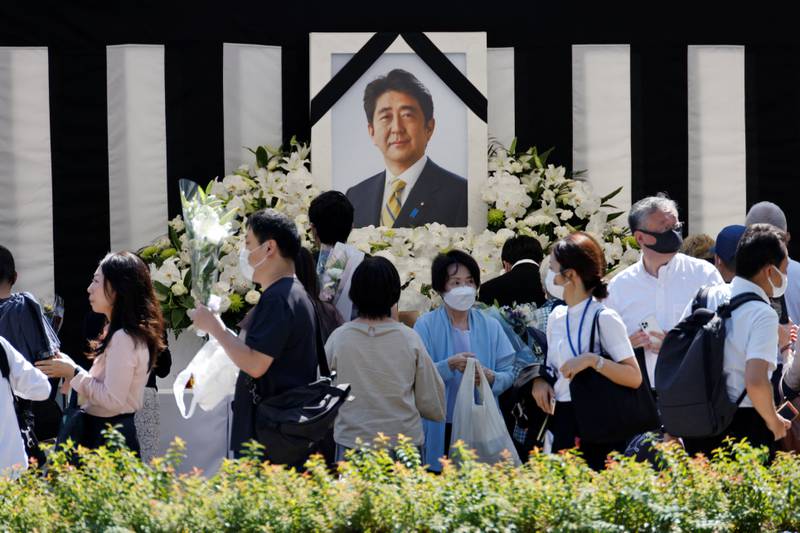 An altar was set up with Abe's picture outside the funeral venue. Reuters