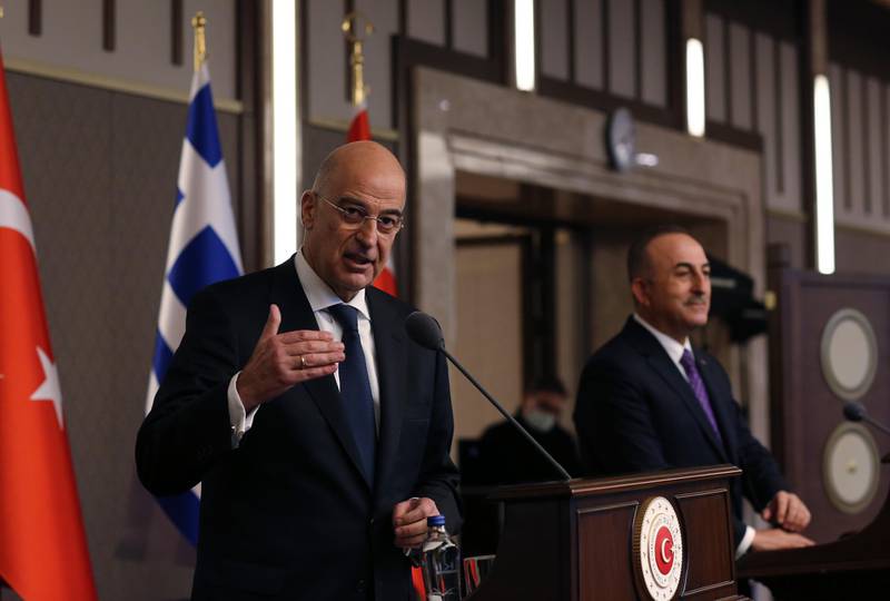 Greek Foreign Minister Nikos Dendias gestures as he talks during a joint media statement with Turkish Foreign Minister Mevlut Cavusoglu, right, following their meeting in Ankara, Turkey, Thursday, April 15, 2021. Dendias visited Ankara Thursday for talks on the two NATO allies' fraught relationship, following a slight easing of tensions between the neighbors. The visit is the first between the two nations following a tumultuous year. (AP Photo/Burhan Ozbilici)