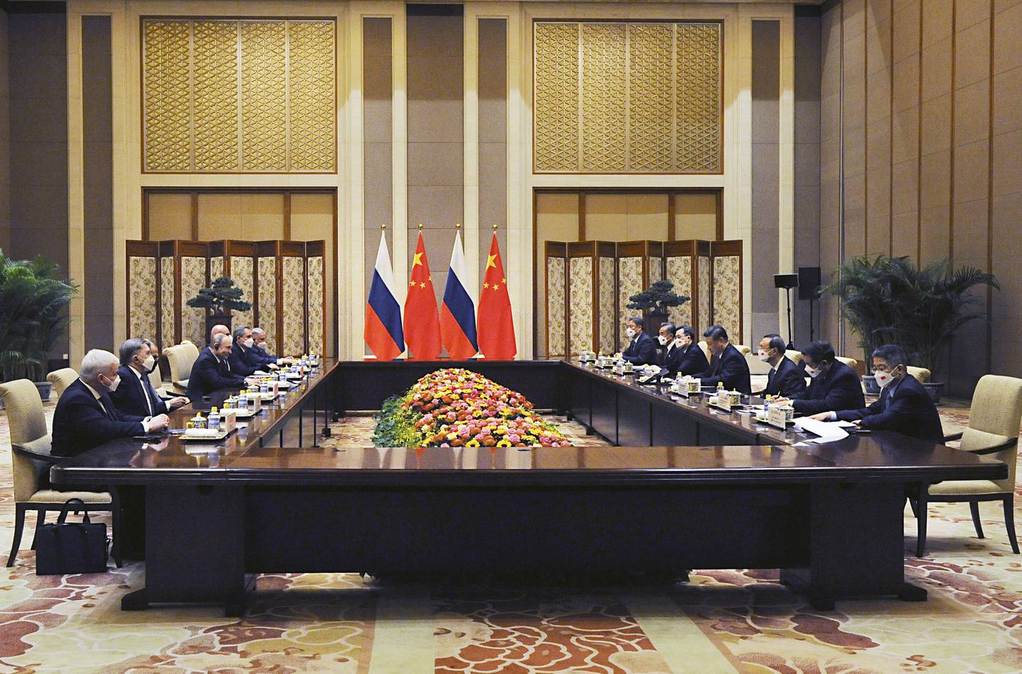 Chinese President Xi Jinping, fourth right, and Russian President Vladimir Putin, fourth left, attend talks in Beijing, China, February  4, 2022. Kremlin Pool Photo via AP
