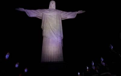 Members of the Red Cross stand at the Christ the Redeemer statue during a tribute to their assistance to Brazilians in tackling the  Covid-19 outbreak, in Rio de Janeiro, Brazil. Reuters