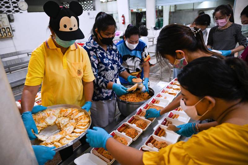 Teachers and volunteers, wearing face masks as a preventive measure against the spread of the coronavirus, prepare food donations for lower-income families organised by the Holy Redeemer Catholic Church at a school canteen in Bangkok. Thailand began easing restrictions on movement and gatherings on May 3, allowing restaurants, hair salons and open-air markets to resume business -- provided that social distancing is maintained and proprietors carry out temperature checks. AFP