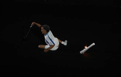 Former Paralympic athlete Marcia Maslar recovers from a fall while carrying the Paralympic flame during the opening ceremony of the Rio 2016 Paralympics Games at the Maracana Stadium. EPA