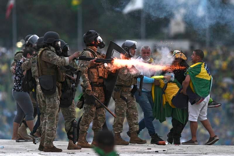 Police confront supporters of Jair Bolsonaro invading the presidential palace. EPA