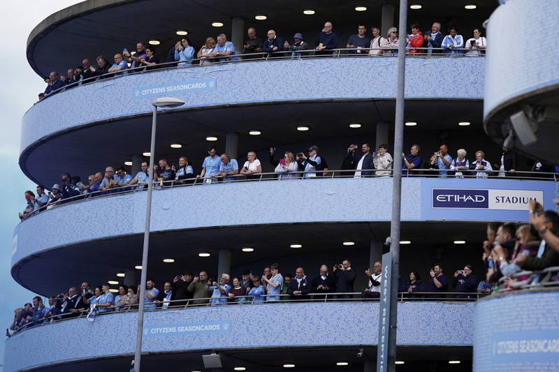 Fans wait for the arrival of Manchester City players. AP