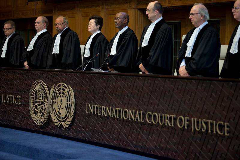 Judges enter the International Court of Justice, or World Court, in The Hague, Netherlands, Wednesday, Oct. 3, 2018, where they ruled on an Iranian request to order Washington to suspend U.S. sanctions against Tehran. (AP Photo/Peter Dejong)
