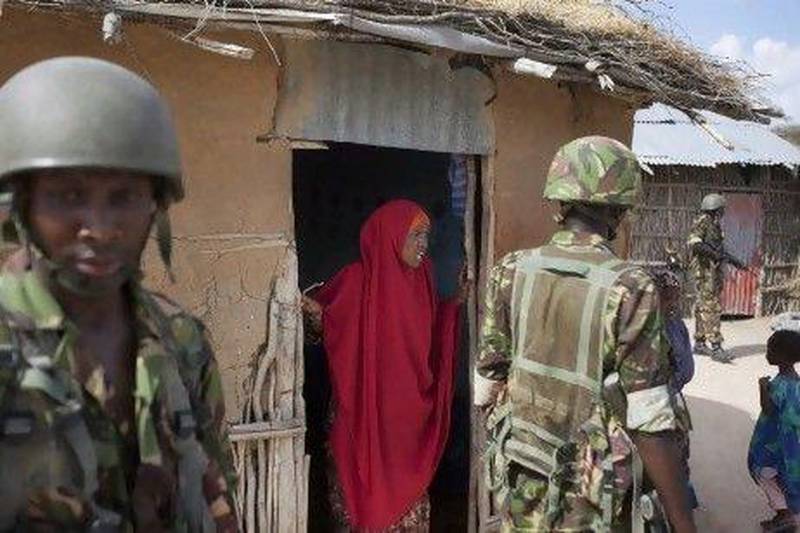Somali villagers, such as this woman talking to Kenyan troops, are keen to get Al Shabab fighters out of their area to allow food aid in.