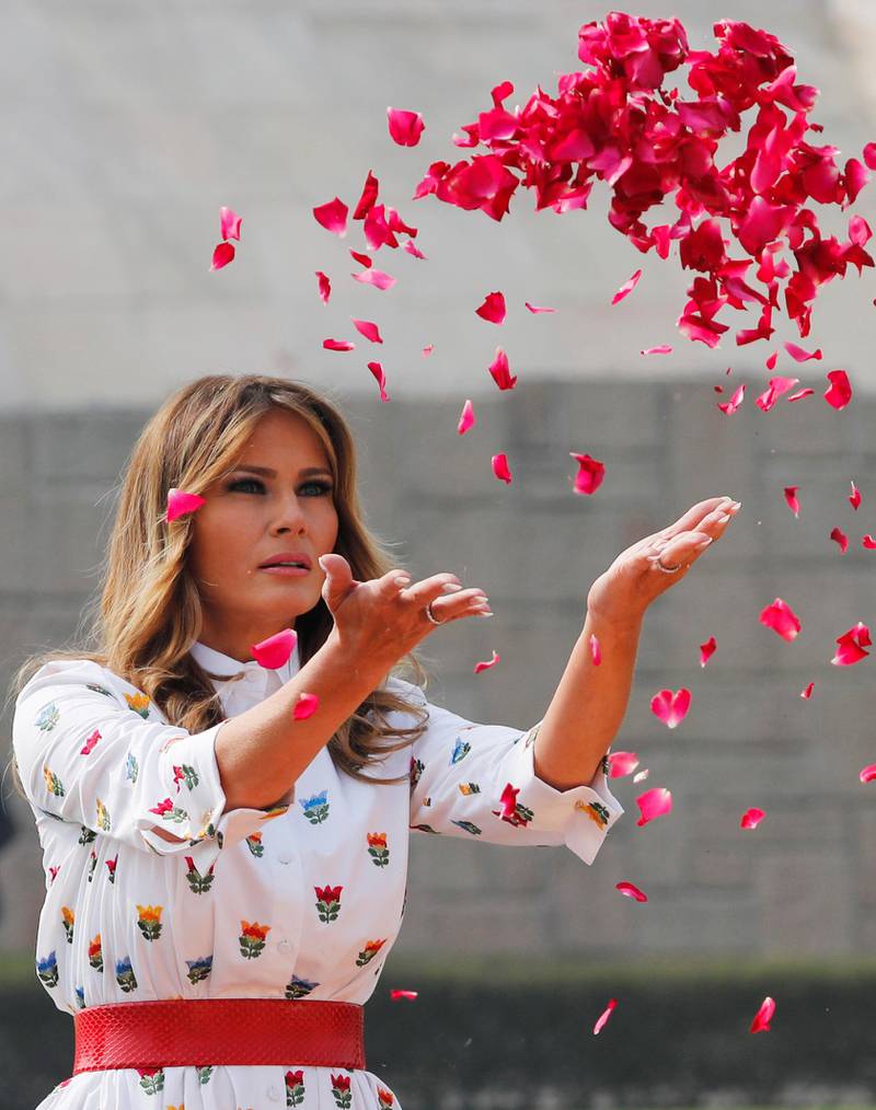 US first lady Melania Trump sprays flower petals during a wreath laying ceremony at Mahatma Gandhi's memorial at Raj Ghat in New Delhi, India. Reuters