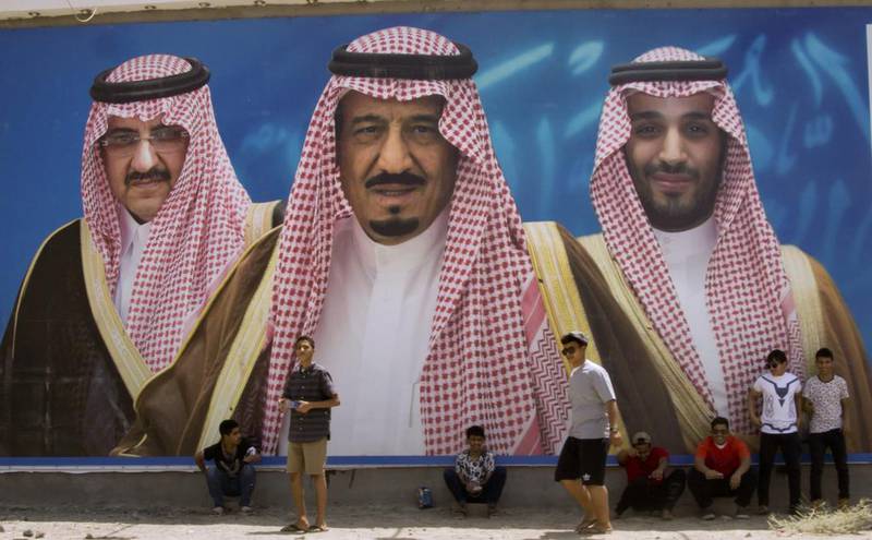 A billboard showing King Salman, centre, with his son, the new Crown Prince Mohammed bin Salman, right, and Prince Mohammed bin Nayef, who was relieved of his duties as Saudi Arabia’s crown prince. Amr Nabil / AP Photo