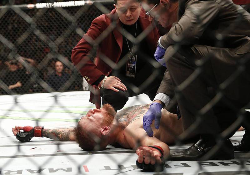 Conor McGregor recovers after a second round-submission to Nate Diaz during their welterweight mixed martial arts match at UFC 196 in Las Vegas. Eric Jamison / AP Photo