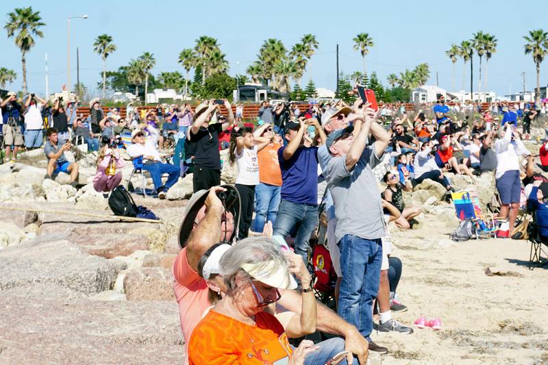 Spectators at Isla Blanca Park on South Padre Island, Texas, look up for a glimpse of SpaceX's bullet-shaped Starship prototype during a test launch. AP