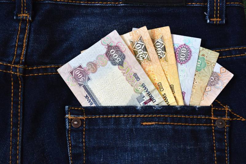 The United Arab Emirates Dirham (Emirati Dirham) currency notes in the Jeans back pocket represents the Income, Cash flow etc. Getty Images
