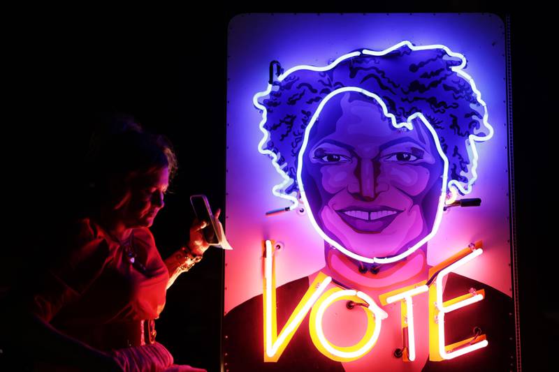 Rachel Lomas, who supports Ms Abrams, stands next to an installation she created on her 'Vote Truck', on November 4, in Midway, Georgia. Getty / AFP