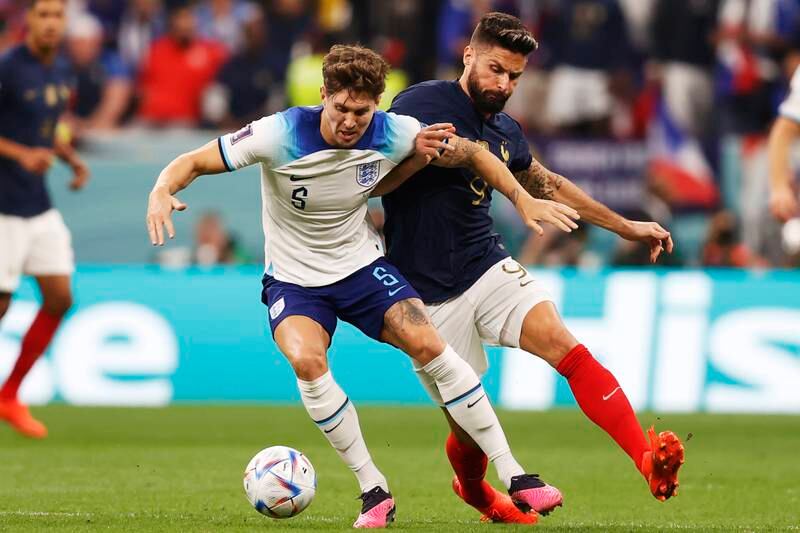 John Stones, left, in action for England against France in the quarter-finals of the 2022 World Cup in Qatar. EPA