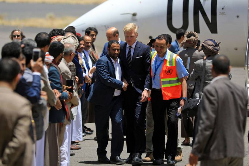 UN special envoy Hans Grundberg, centre, is received upon his arrival at Sanaa Airport in the Yemeni capital.  AFP
