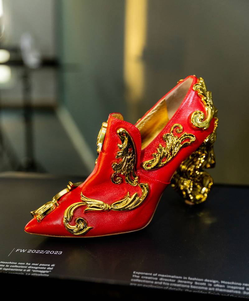 A red and golden shoe by Moschino