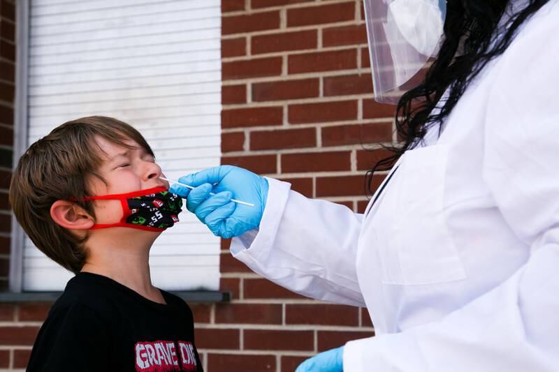 Nurse Alisa Ellis-Balogun tests 7-year-old Thomas Byrd for coronavirus at Seneca High School a day before returning to school in Louisville, Kentucky, US, on August 10, 2021. Reuters