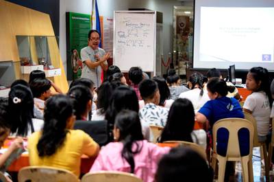 This photo taken on July 6, 2019 shows cultural advocate Leo Emmanuel Castro teaching students the indigenous script known as Baybayin, used before Spanish colonisation in 1521, in Manila. From tattoos, shirts, and artworks to a computer font and mobile apps, Baybayin found a rebirth among millennials and professionals learning its 17 characters beyond the marginal mention in history class. 
Photos: AFP / Noel Celis