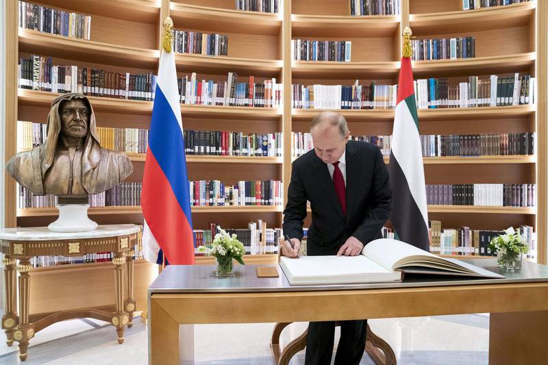 ABU DHABI, UNITED ARAB EMIRATES - October 15, 2019: HE Vladimir Putin Vladimirovich, President of Russia (C), signs the guest book during a state visit at Qasr Al Watan. ( Mohamed Al Hammadi / Ministry of Presidential Affairs )---