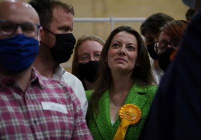 Sarah Green of the Liberal Democrats smiles after after being declared winner in the Chesham and Amersham by-election at Chesham Leisure Centre in Chesham, Buckinghamshire, England where she defeated Conservative candidate Peter Fleet early Friday June 18, 2021. (Yui Mok/PA via AP)