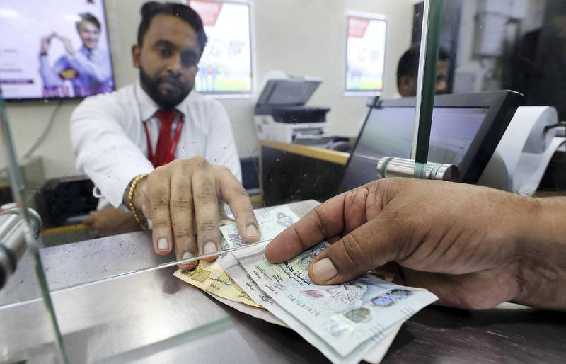 DUBAI, UNITED ARAB EMIRATES, August 30 – 2018 :-  Indian expats sending money back home from UAE exchange at the Al Quoz Mall in Al Quoz Industrial area in Dubai. Indian rupee hitting another record low of 19.22 against the UAE dirham on Wednesday.  ( Pawan Singh / The National )  For News. Story by Ramola 