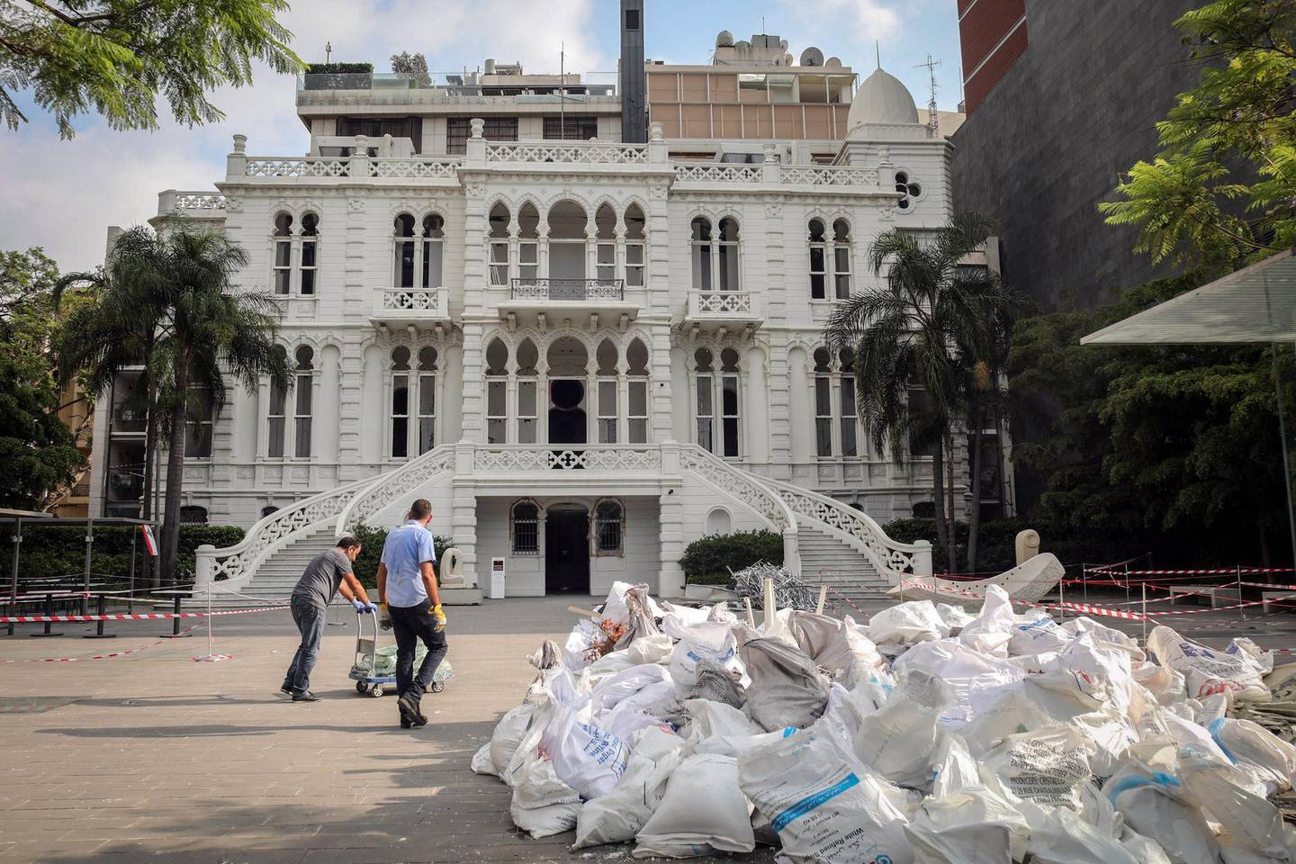 Workers transport bags of rubble outside the Nicolas Ibrahim Sursock Museum in Beirut, Lebanon, on Wednesday, Aug. 12, 2020. Lebanon was already coming apart at the seams before a 2,750-ton cache of ammonium nitrate detonated at the Port of Beirut, killing at least 171 people and wounding thousands. Photographer: Hasan Shaaban/Bloomberg