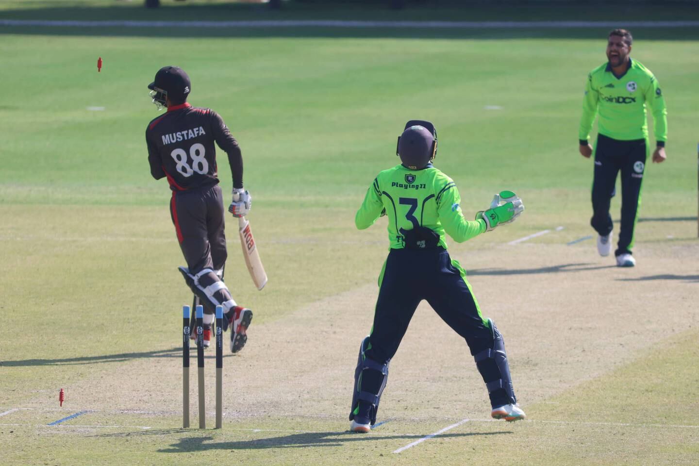Simi Singh of Ireland takes wicket of Rohan Mustafa in the ICC World T20 Global Qualifiers A match between Ireland and the UAE in Muscat, Oman, on February 18, 2022.
